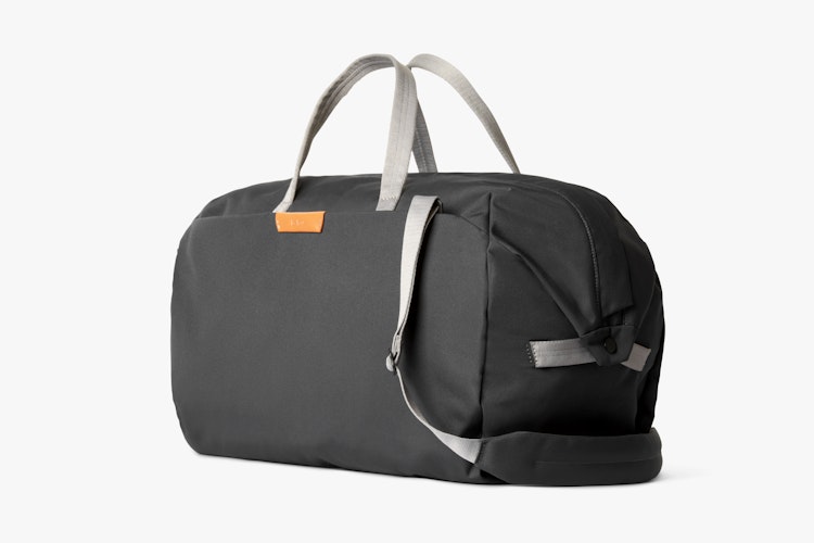 Bellroy Classic Weekender 45L black duffel bag with slate gray handles, shoulder strap and ribba fabric texture on white background.