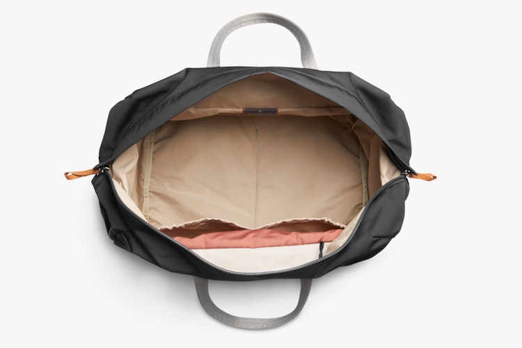 Top view of open Bellroy Classic Weekender 45L, showing black ribba weave exterior, beige lining, spacious main compartment, handles.