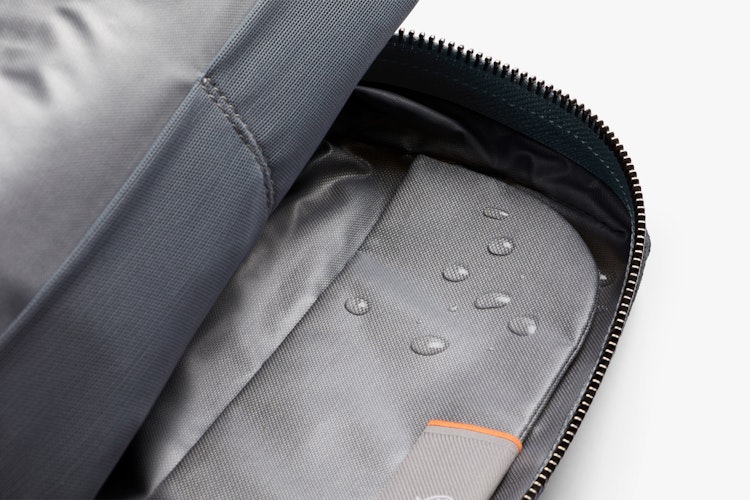 Product gallery image showing a slate gray Bellroy Toiletry Kit, unzipped to display its water-resistant ribba weave and organized interior.