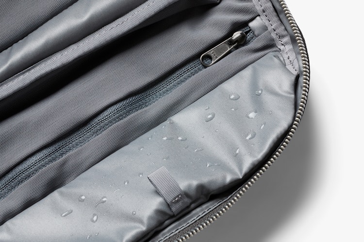 Product gallery: Close-up of the interior of the Bellroy Toiletry Kit Plus in slate gray with water-repellent lining and zippered pocket.