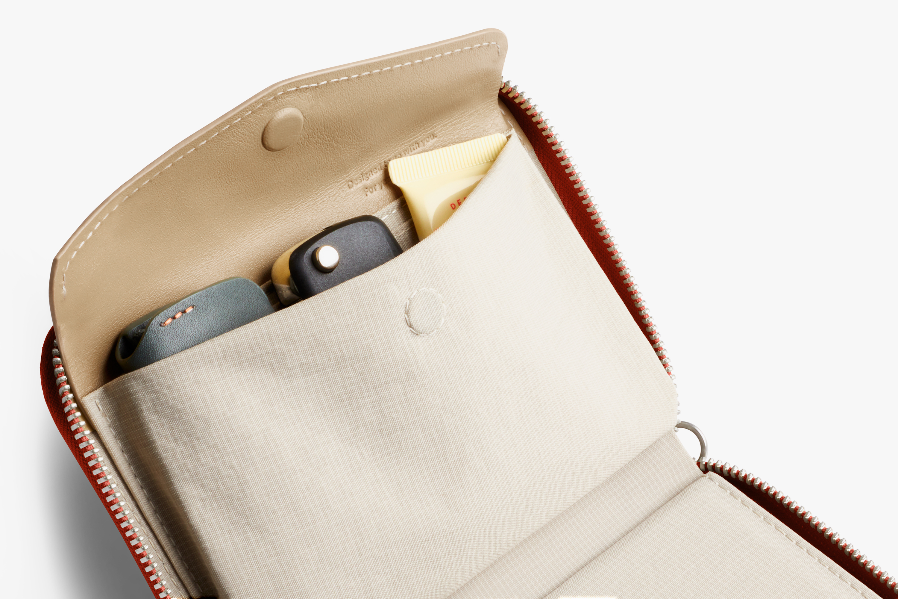 Bellroy folio wallet in beige leather with RFID protection, a zipper, a snap pocket and a small-item compartment.